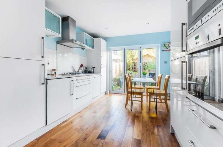 It leads on to a modern kitchen/diner with folding doors to the garden (Image: Gibson Lane)