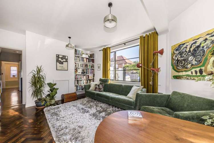 The flat has modern neutral decor with white walls and herringbone wood block flooring (Image: Dexters)