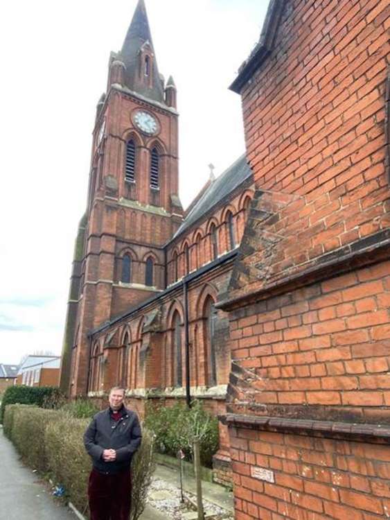 Father Hislop outside the church (Image: Nub News)