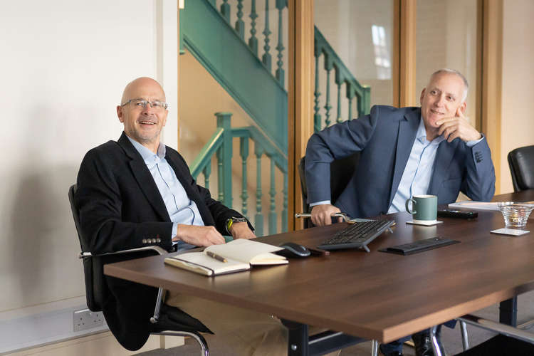 Jason (right) at a board meeting in the firm's Hampton Wick premises