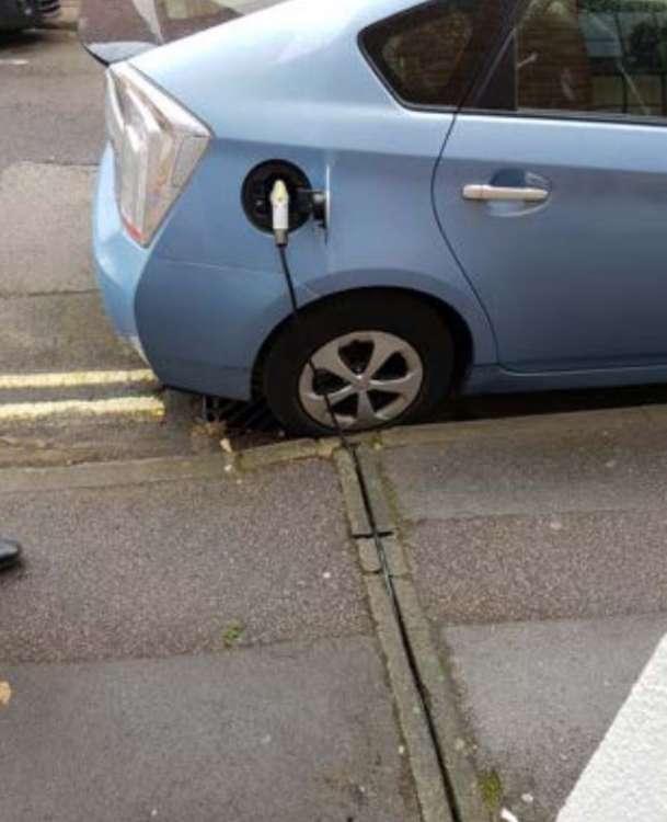 The idea of installing channels under pavements to allow residents to run cables from their homes to charge electric cars is being investigated by the Council. Credit: Oxford City council.