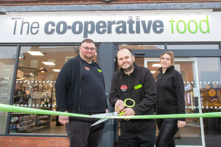 Store Manager Chris Watson (centre) and colleagues cut the ribbon on the new Central England Co-op in Market Street, Ashby