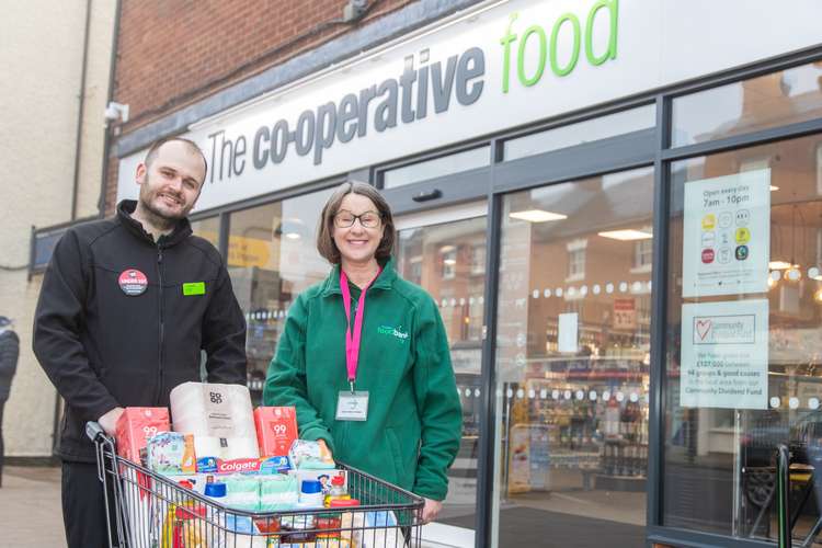 Store Manager Chris Watson donates a trolley full of food and essentials to Ashby Foodbank to mark the launch