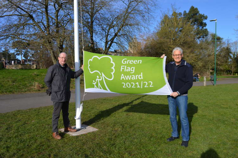 Councillor Roger Bayliss (left), Chairman of the Parks & Cemetery Committee, with Town Councillor Mike Ball (right), Chairman of the Ashby Bath Grounds Advisory Group, raising the Green Flag on Ashby Bath Grounds on the newly installed flag pole