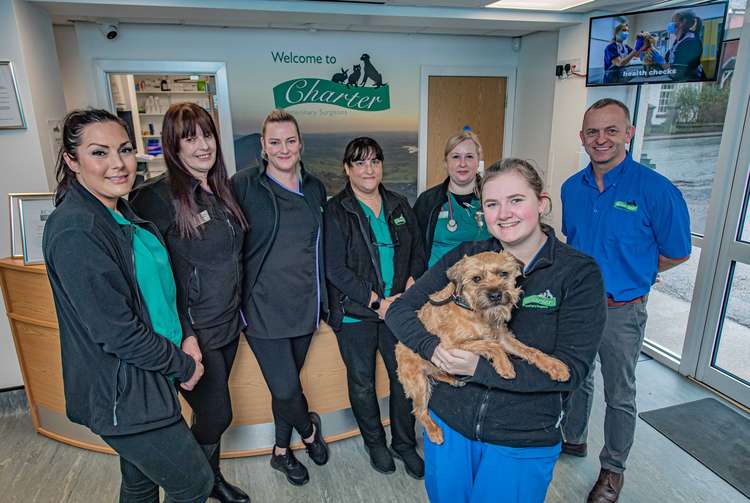 A happy customer at Charter Veterinary Surgery at Biddulph, Wilf in the arms of Charlotte Shore at , with, from left, Gemma Boughey, Ray Wallis, Gemma Beech, Jenni Ramcharan, Sam Smith and Clinical Director Marcus Johnstone.