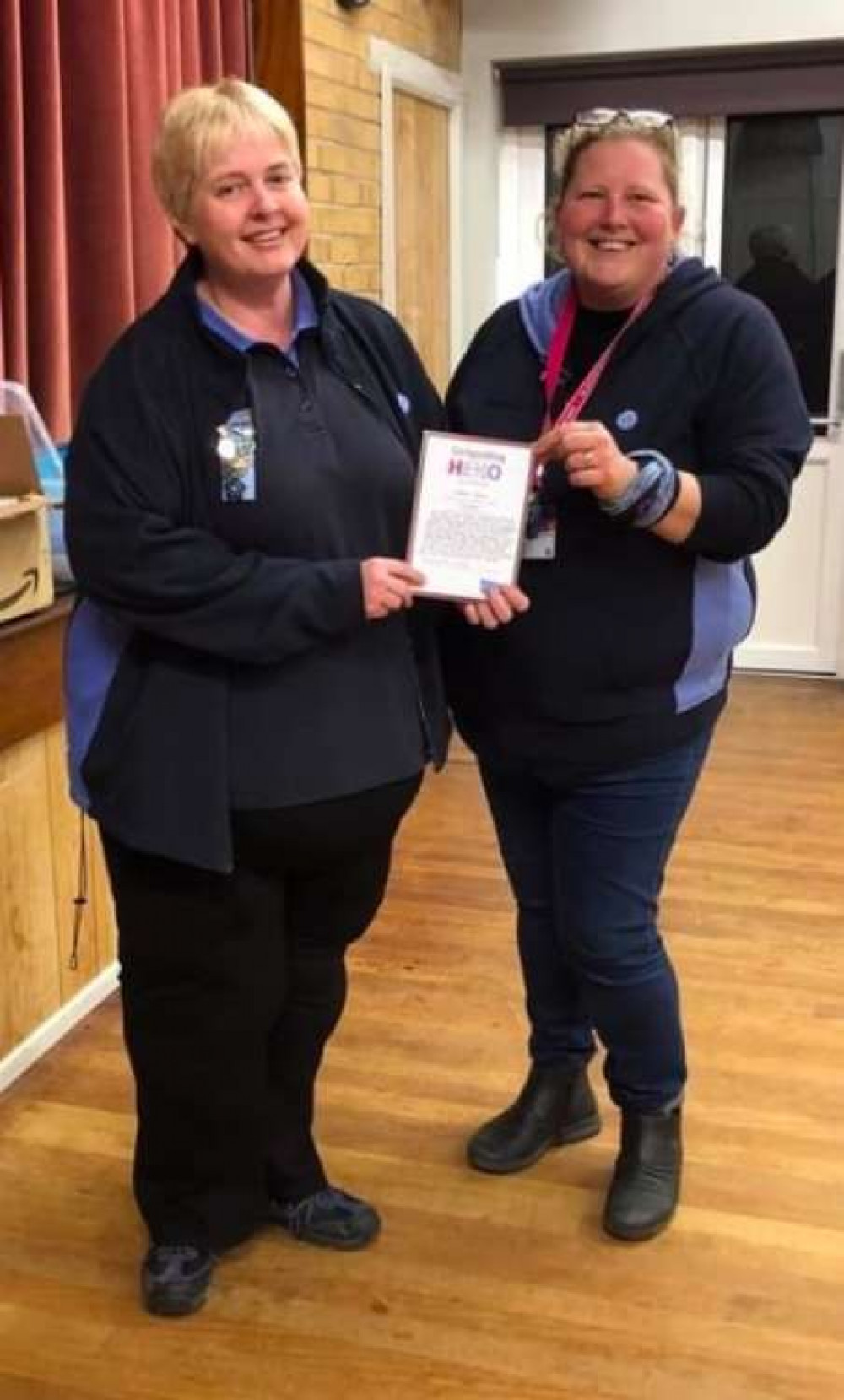 Girlguiding leader Emma House, right, receives the Girlguiding Hero Award from Dorset County commissioner Lisa Upward