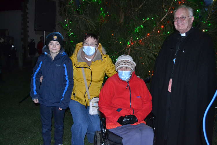 The lights were turned on by Harbour House resident Liz Pawley, second right, with help from her grandson Sebastian, left, pictured with the Rev Philip Ringer, right, and carer Chrissy Read