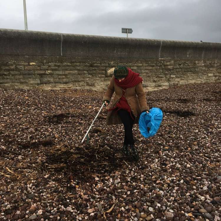 More than people 100 took to West Bay for a beach clean in memory of Simon Jordan (Image: courtesy of Roy Beal)