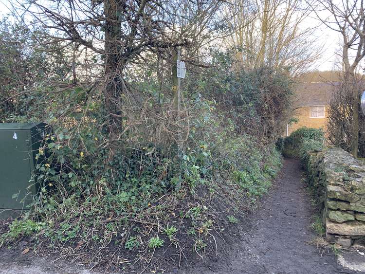 Go down the footpath on your left before the stone wall