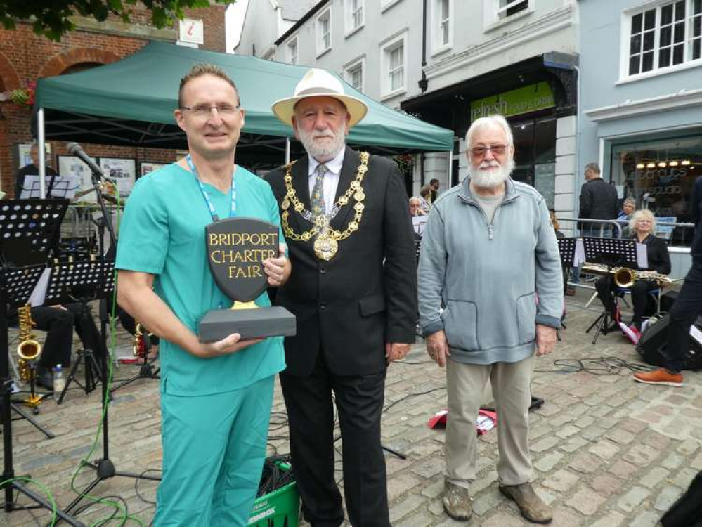 Bridport Charter Fair will return this year with a new venue, date and set up, pictured, is the awarding of the Charter Fair Trophy last year to Dr Finucane