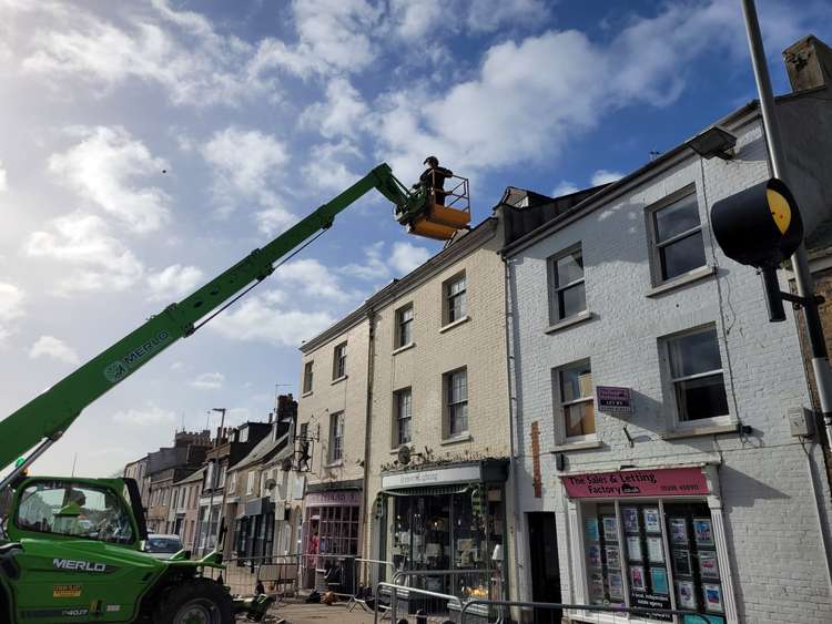 Town council staff securing the roof at Bridport Lightening