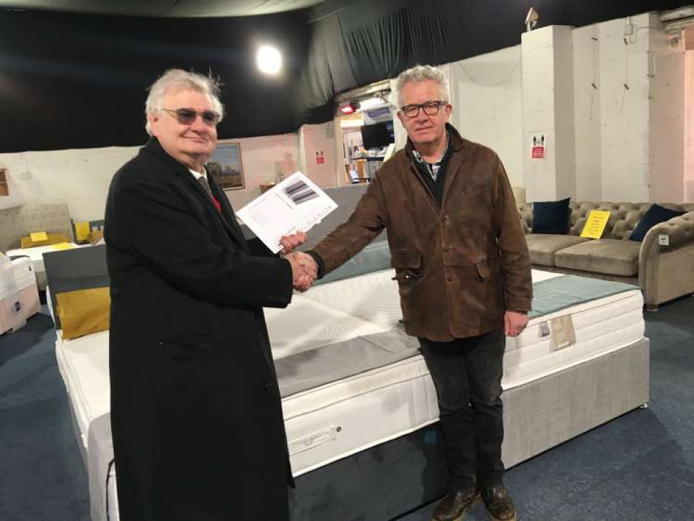 Simon Dorrington Ward, treasurer of St Mary's Lodge, presenting a cheque to Bridport Refuge Support Campaign chairman, Barry Lovejoy