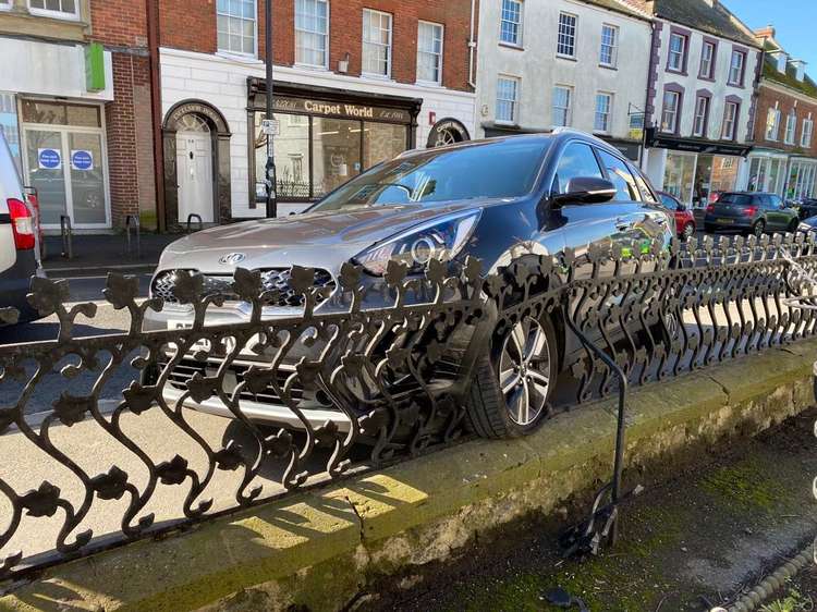 A car has crashed into railings in Bridport's West Street