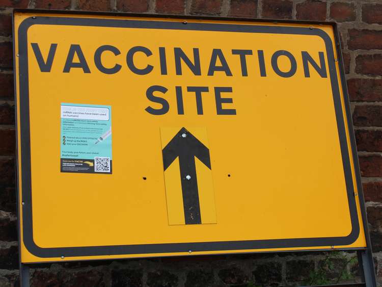 A vaccination site sign with anti-vcxx propaganda placed on it, at Congleton's Market Square.