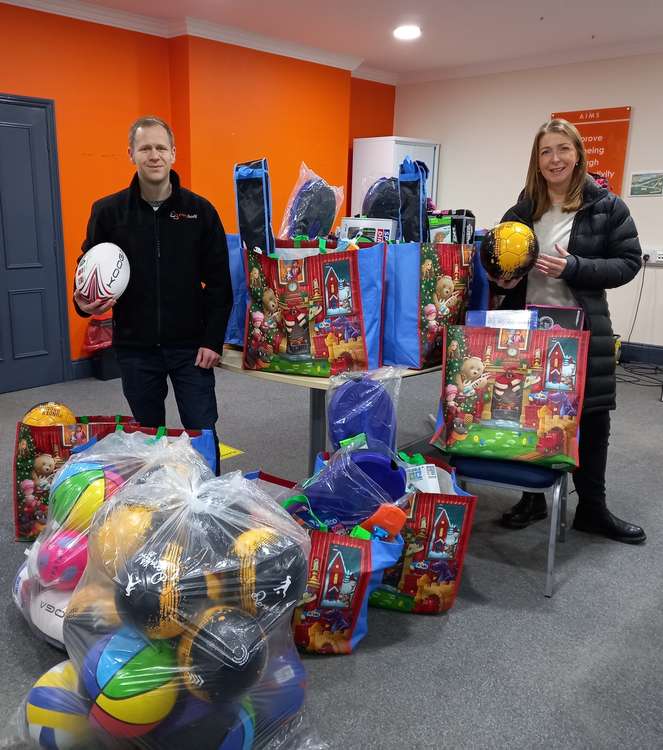 Lee Malkin and Sara Pedersen of Everybody Fitness helped collate staff's donations.