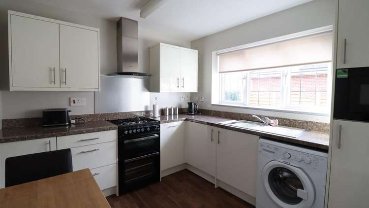 A modern kitchen with views of your large lawn is a great place to cook your evening meals.