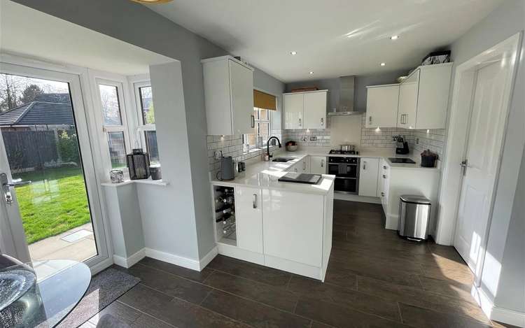 The up-to-date kitchen looks out onto the large garden, and just out of frame to the right of this picture is a great little utility room.