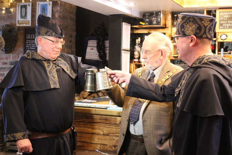 Local designer Jenny Unsworth created medieval-style outfits for Ale Taster (left) and Town Crier Rob Moreton. Congleton Mayor Denis Murphy also has a sip.