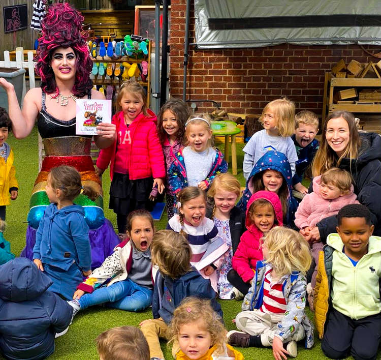 Aida H Dee with children at a story session. (Image credit: Drag Queen Story Hour UK)