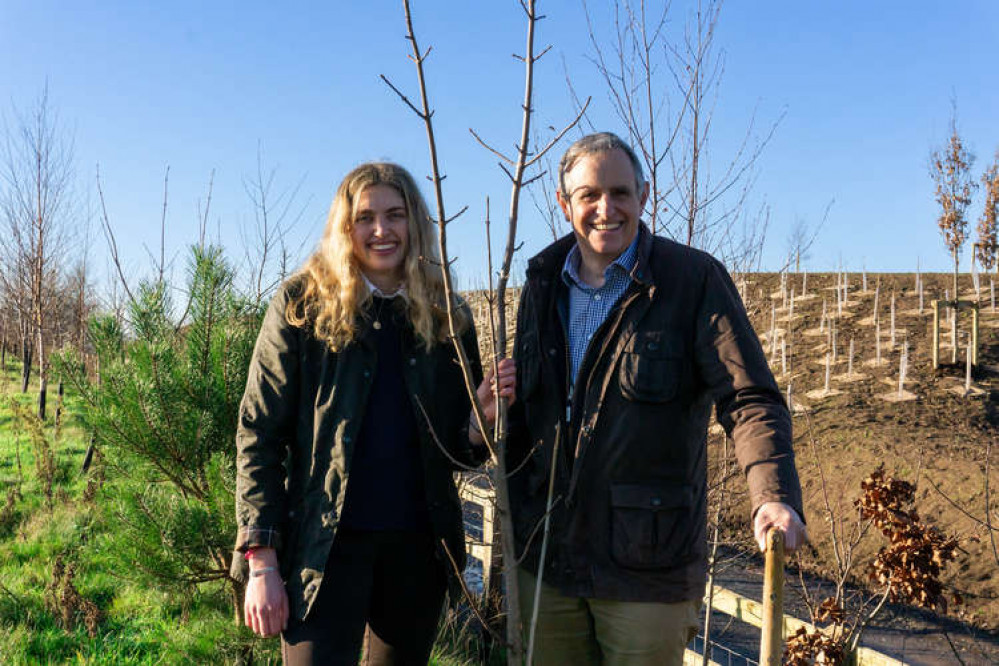 Eleanor Thatcher and Martin Thatcher plant one of ten native coppice trees alongside the Strawberry Line for the Queens Green Canopy Campaign