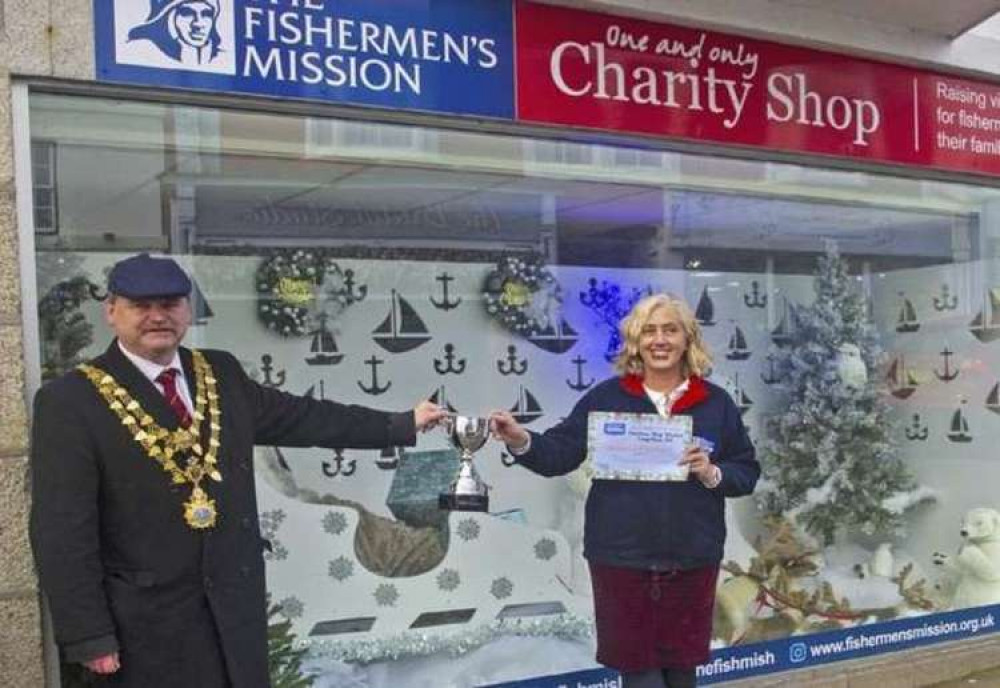 Winner of the window competition Fishermen's Mission (Melinda King), with the mayor. Shared by Discover Helston.