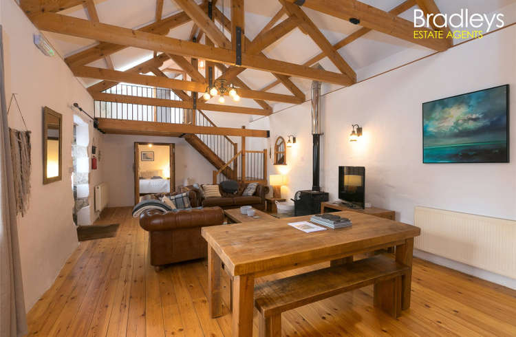The property oozes character with open plan living spaces, and exposed beams.