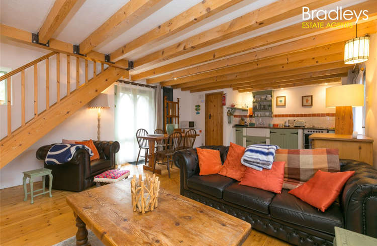 The property oozes character with open plan living spaces, and exposed beams.