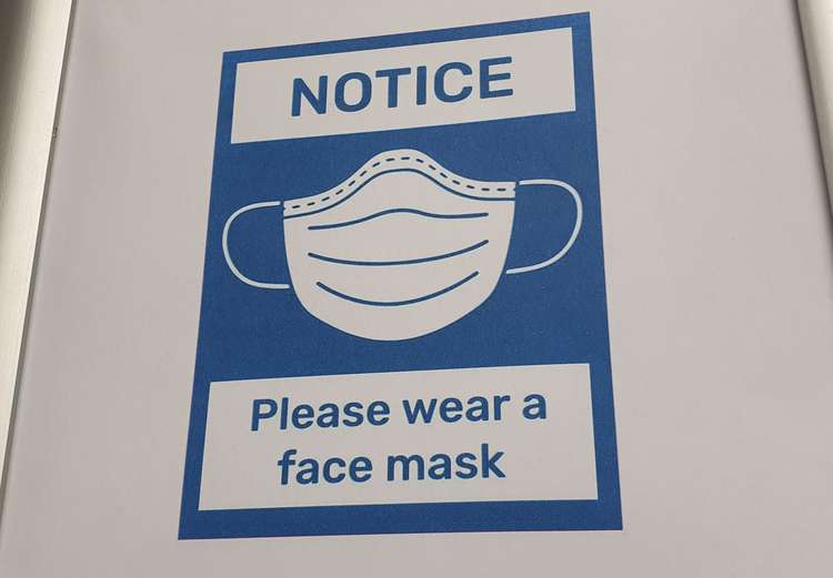 A sign reminding customers to wear a face mask in a Honiton shop