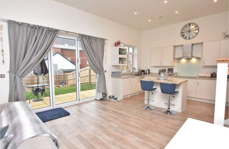 The kitchen and living space has tall ceilings, large windows and bi-fold doors looking onto the rear garden (Bradleys)