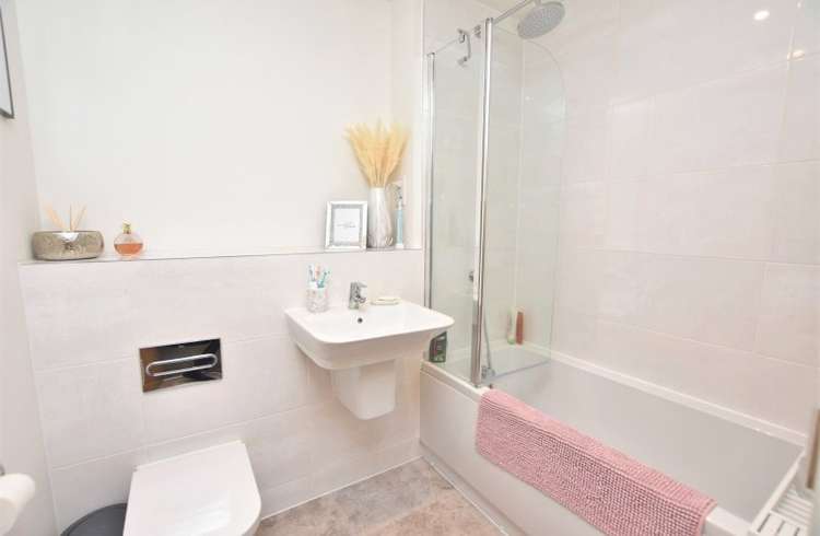 The modern bathroom is family-sized and has a shower over the bath (Bradleys)