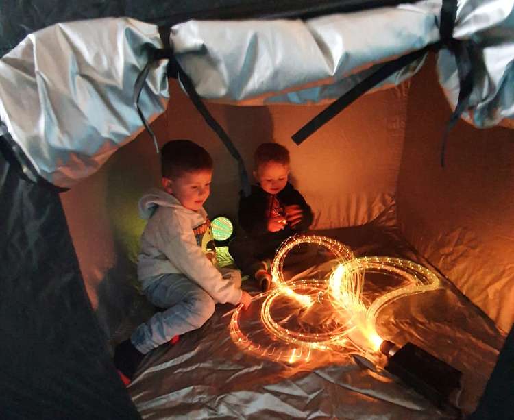 Alfie Clarke (left) and Travis Boyce enjoying the new sensory tent. Credit: Di Virgin