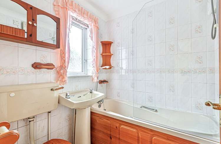 The bathroom features a three-piece suite with shower over the bath (Bradleys)