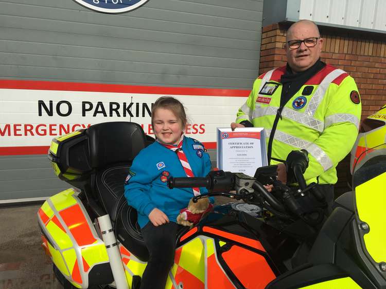 Elsie Horn, aged six, was presented with a certificate of thanks by Devon Freewheelers deputy CEO, Russell Roe. Credit: Devon Freewheelers