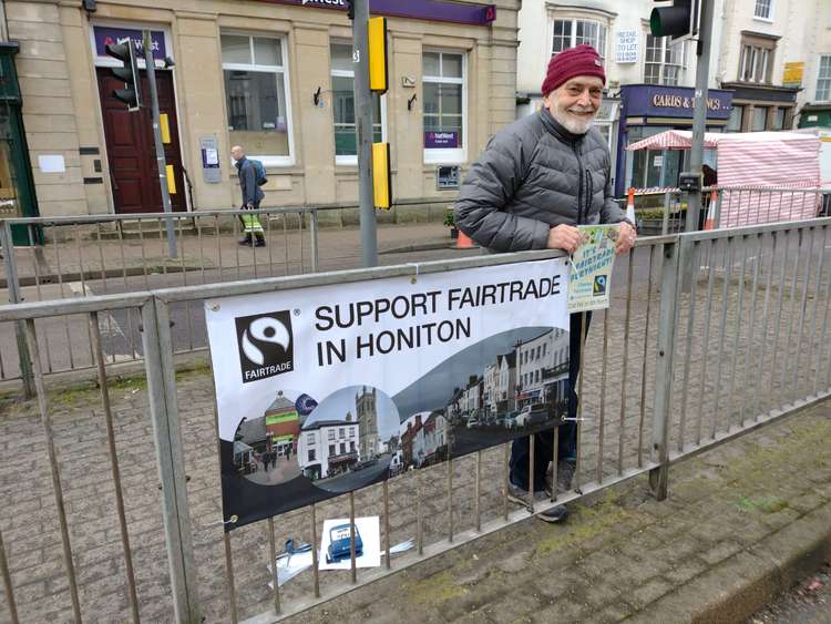 Geoff Gilbert with a Fairtrade information banner in Honiton. Credit: Caroline Kolek