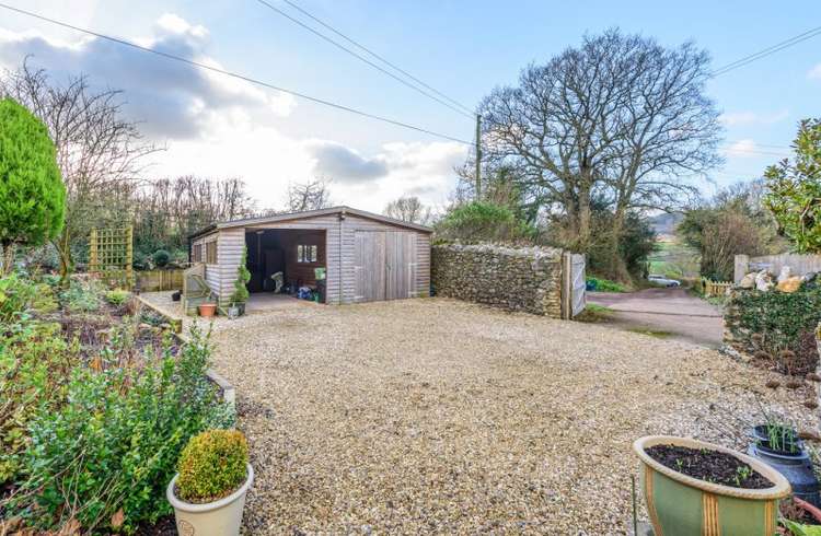 The house offers plenty of parking space and a garage. Credit: Bradleys Honiton.