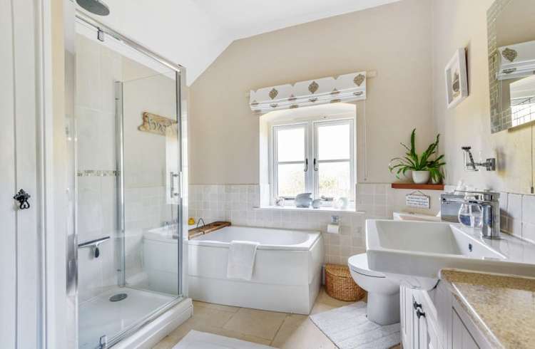 The bathroom has a bath and a separate shower. Credit: Bradleys Honiton.
