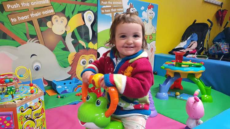 The café has a baby pen for younger children and a slide and climbing area.