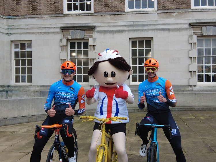 The Tour of Britain will not visit Hucknall this year. Pictured: Ribble Weldtite cycling team members Ollie Peckover and Ross Lamb with Tour of Britain mascot ToBi. Image: LDRS.