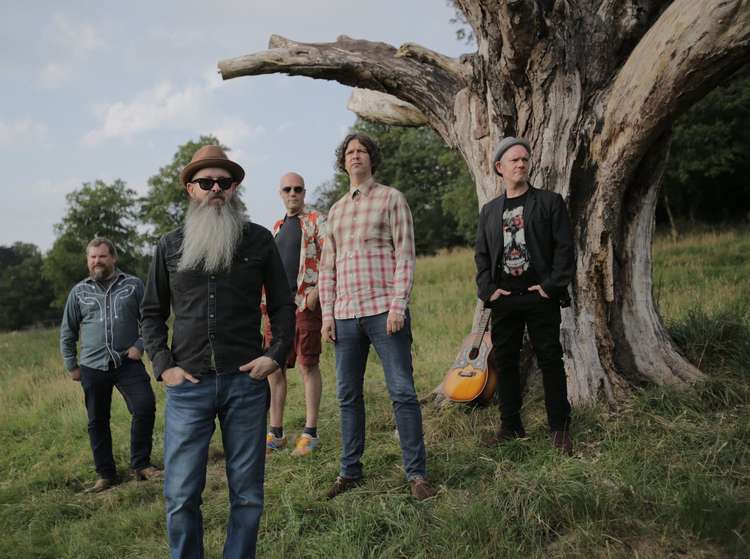 Field Manual: Chris Insley (centre) and the band pose in front of a tree in Leek. Their new single 'Home' is out now. (Image - Field Manual / Instagram @fieldmanualband)