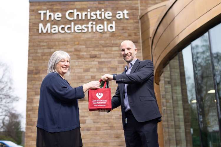 Sue Thompson receiving a gift bag from Christie medical director Dr Neil Bayman.