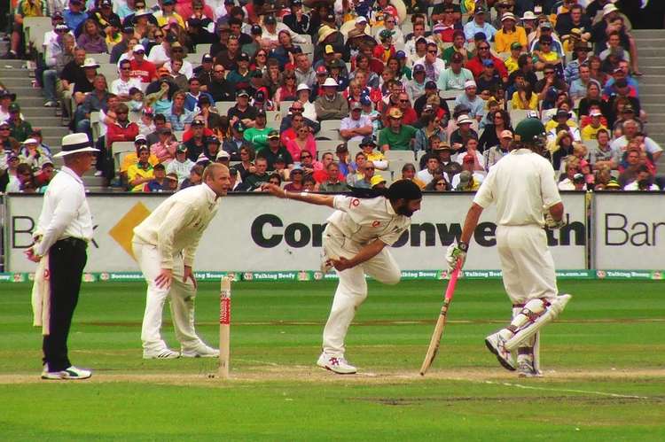 Monty Panesar bowls during the 2006–07 Ashes series as Andrew Flintoff watches. (Image - CC 2.0 Flickr (User:mugley) bit.ly/3pSXv5G Unchanged)