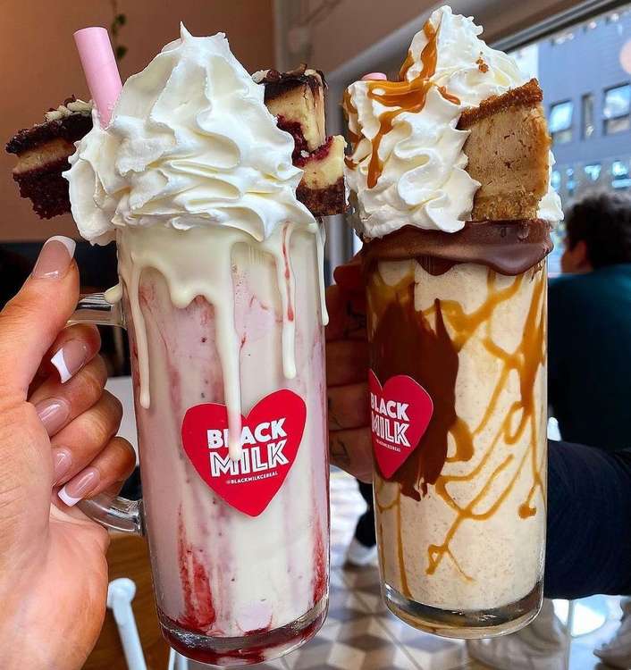 Strawberry and white chocolate milkshake topped with red velvet cheesecake and Biscoff milkshake topped with lotus Biscoff cheesecake at their Manchester offering, and will be coming to Macc. (Image - Instagram @blackmilkcereal)