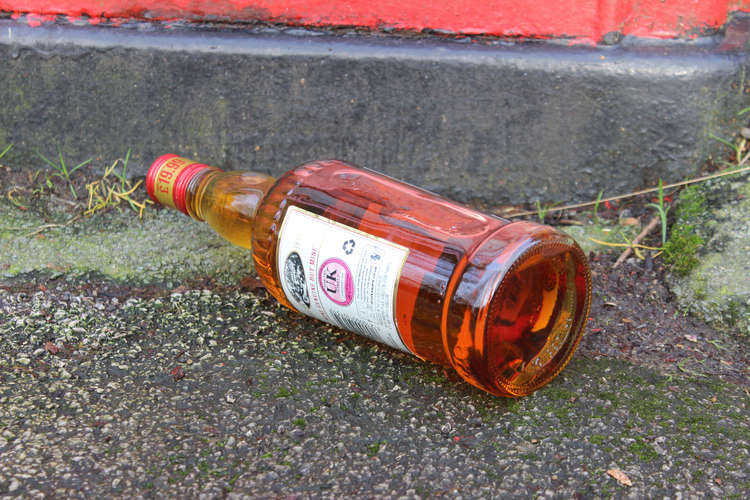 A bottle of alcohol next to a phone box in Macclesfield. Please note: This photo is not real and is purely for illustrative purposes.