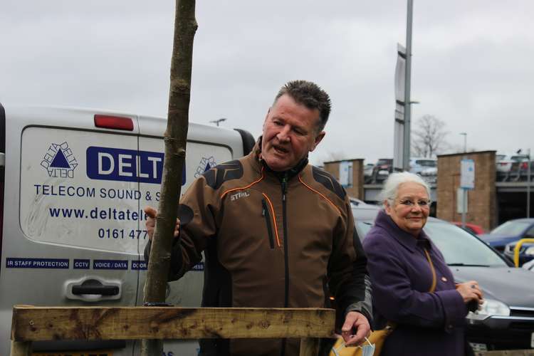 Ranger Andy McKeith nurtured the tree before Monday's planting.