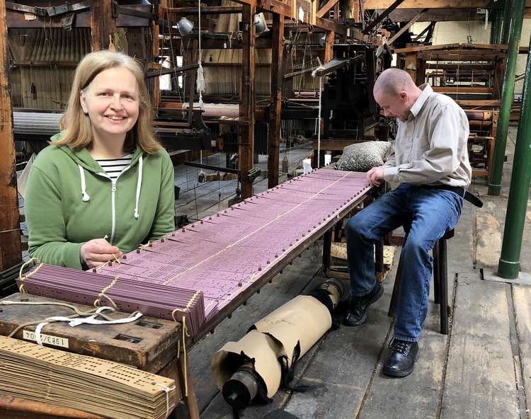 Trish Halloran and Daniel Hearn take pride in restoring the loom and threading the Jacquard card at Paradise Mill. (Image - Macclesfield Museums)