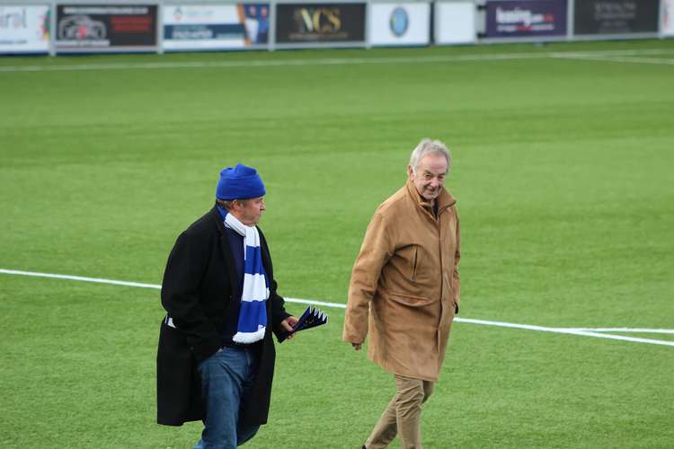 Carl (right) gives a wink to the crowd in Silkmen Terrace. To the left of him is life-long Macc FC fan Philip Gibbons, who fondly remembers watching Carl. (Image - Alexander Greensmith / Macclesfield Nub News)