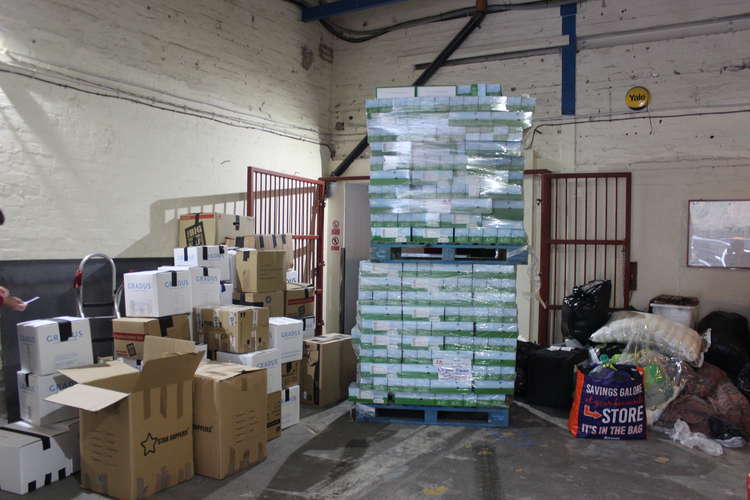 A huge donation of tinned food stands tall on the ground floor of this two-floor operation.