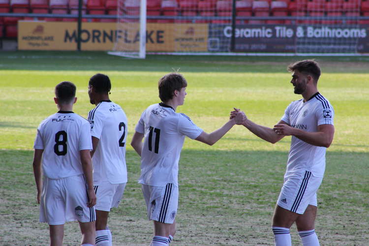 Berry and Clare shake hands in celebration. Clare described the fans as 'amazing' and thanked them for their 'non-stop support' on Twitter. (Image - Alexander Greensmith)