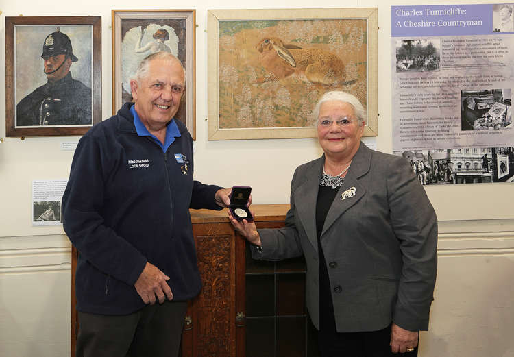 David Tolliday of the RSPB Macclesfield Local Group presents the replica medal to Janet Jackson MBE, a trustee of The Silk Heritage Trust and Chair of the Friends of Silk Heritage