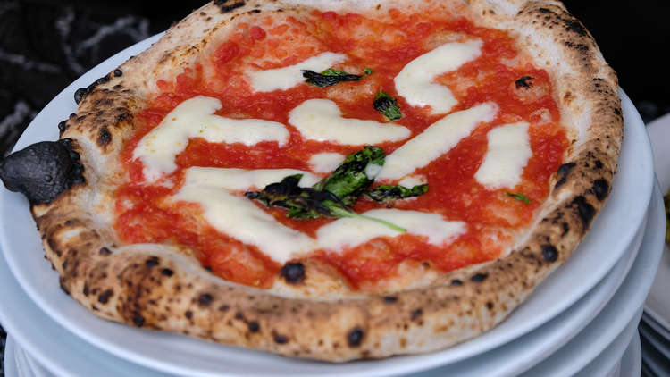 The margherita is made up of simple and quality ingredients. It comprises San Marzano tomato, mozzarella, basil, and extra virgin olive oil. (Image - Claire Harrison Photography)